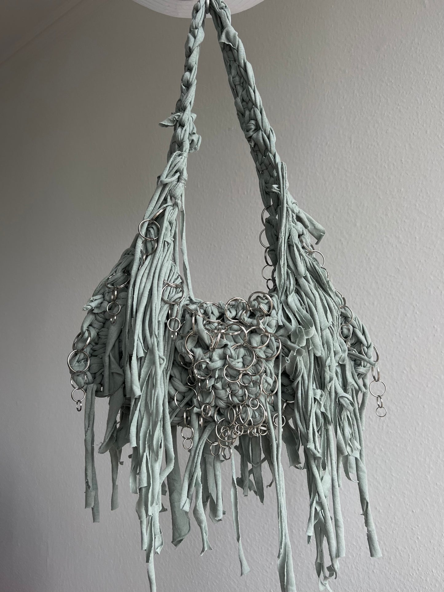 Green fringe bag with metallic rings