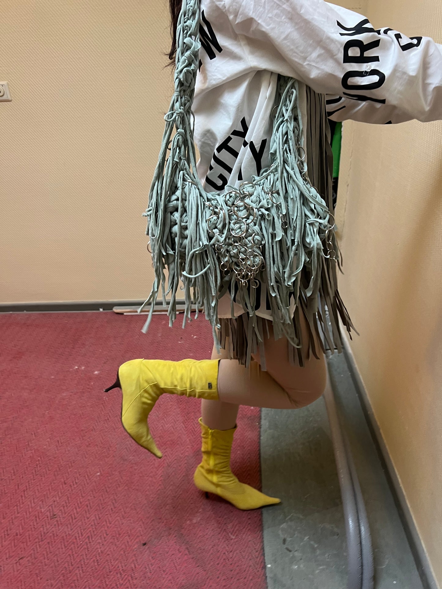 Green fringe bag with metallic rings