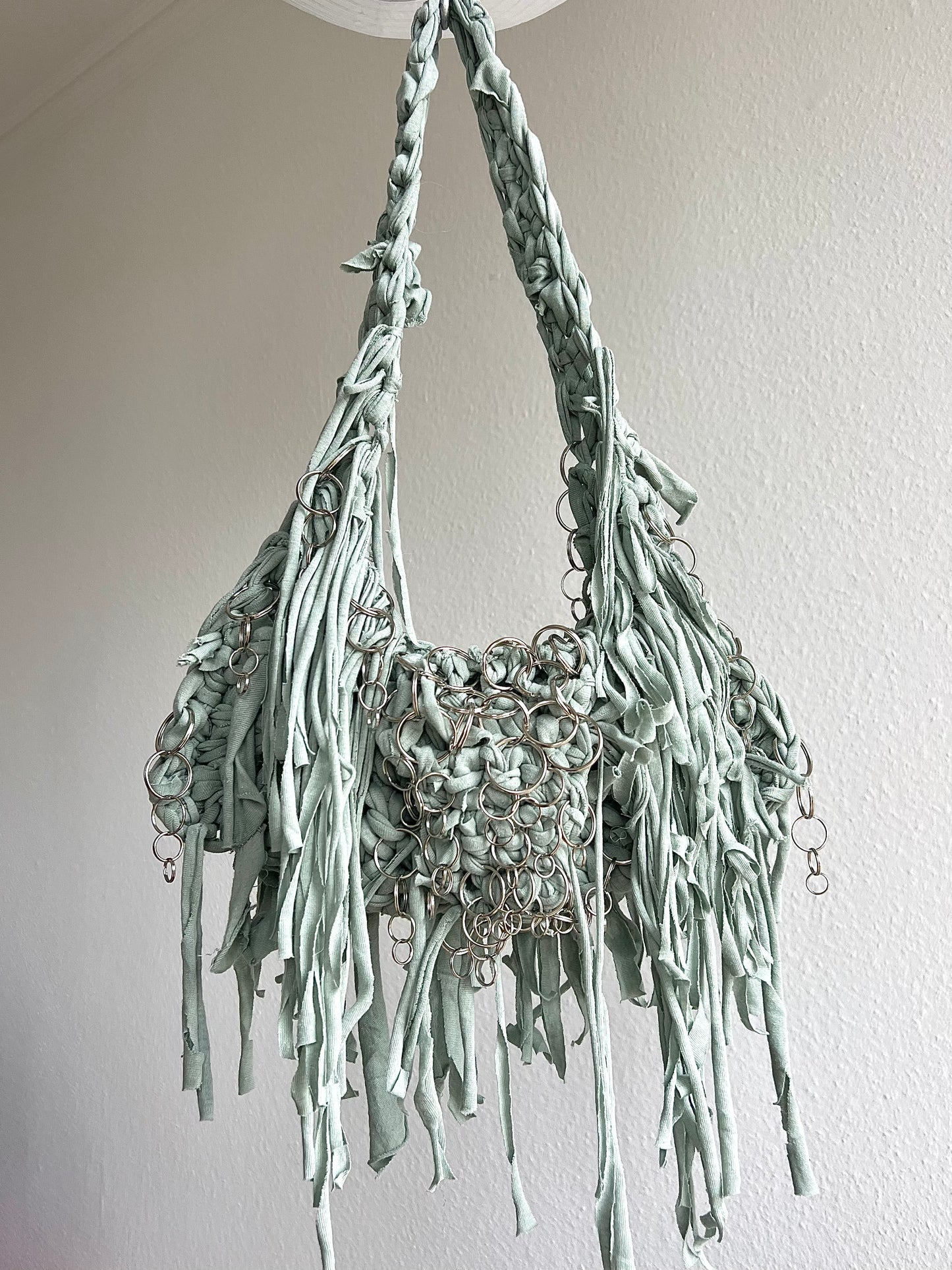 Green fringe bag with metallic rings