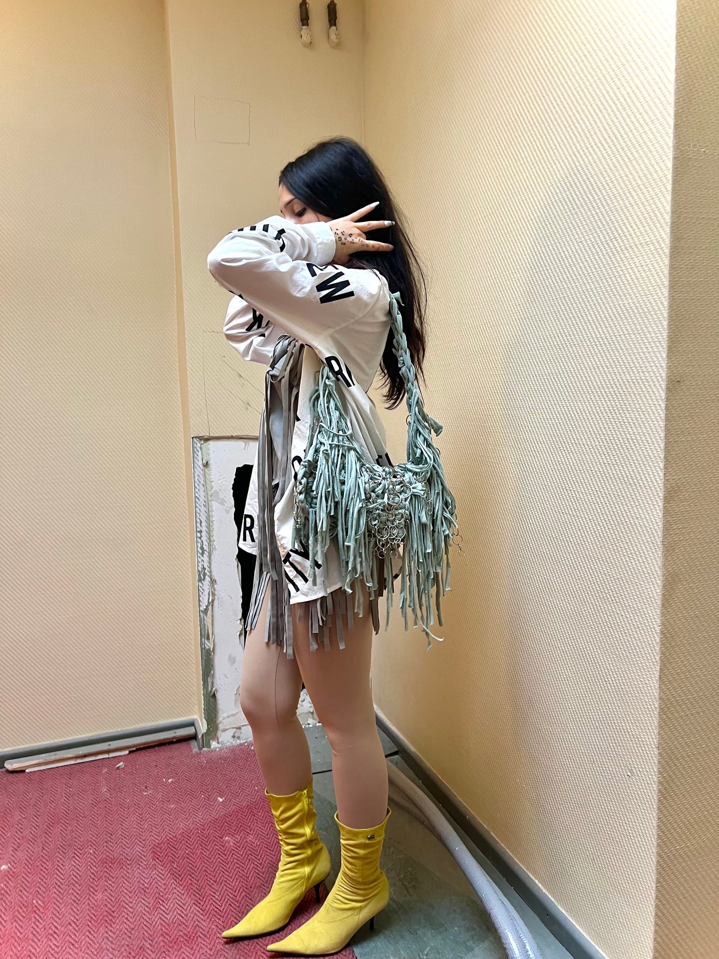 Green fringe bag with metallic rings